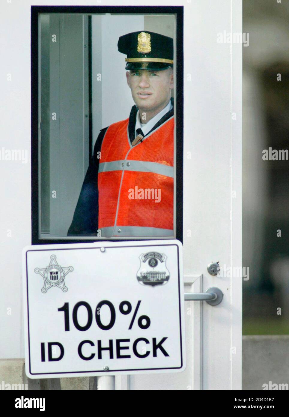 A U.S. Secret Service Uniformed Division Officer stands watch at a checkpoint on the perimeter of the White House compound in Washington, March 19, 2003. Security levels have been elevated in the Nation's Capital after U.S. President George W. Bush announced March 17 that Iraqi President Saddam Hussein and his sons have 48 hours to leave Iraq, and if they do not the U.S. will commence a military assault on his regime. REUTERS/Larry Downing  LSD/HB Stock Photo