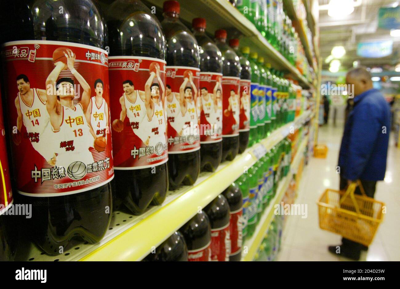 A Chinese Shopper Looks At Softdrinks Near Coca Cola Bottles Featuring Chinese National Players At A Supermarket In Shanghai May 27 03 Chinese Basketball Player Yao Ming Is Suing Coca Cola For One