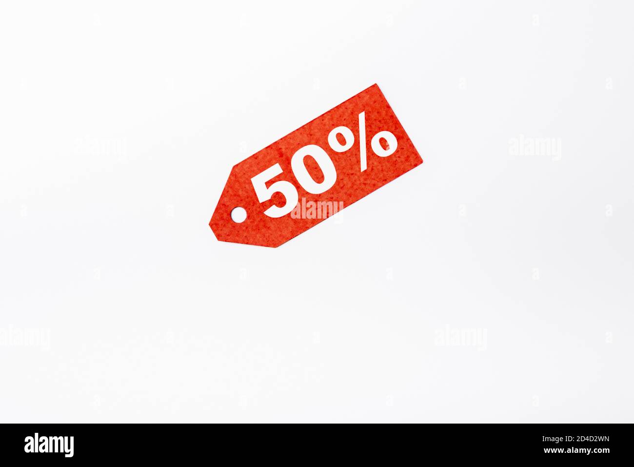 Top view of red price tag with fifty percent signs on white background ...
