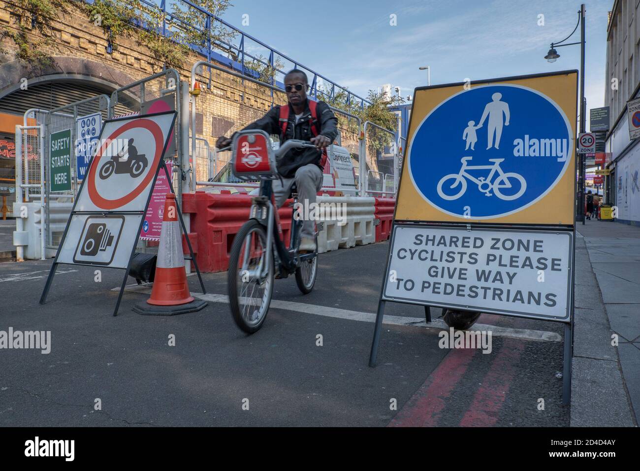 A man cycling on a Santander Cycle on Atlantic Road on the 16th September 2020 in Brixton in the United Kingdom. Photo by Sam Mellish Stock Photo