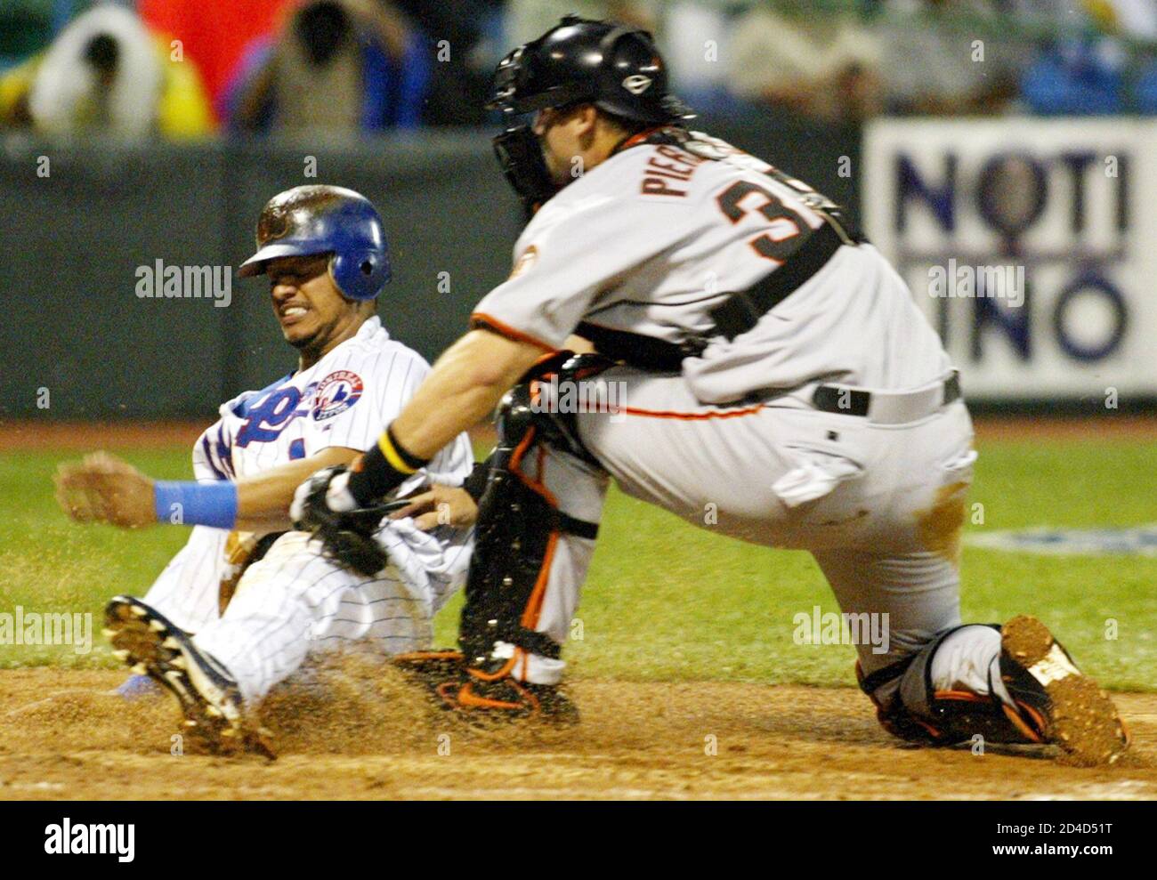 Montreal Expos runner Orlando Cabrera (L) is tagged out at home plate by  San Francisco Giants catcher A. J. Pierzynski in the fourth inning at the  Hiram Bithorn Stadium in San Juan,