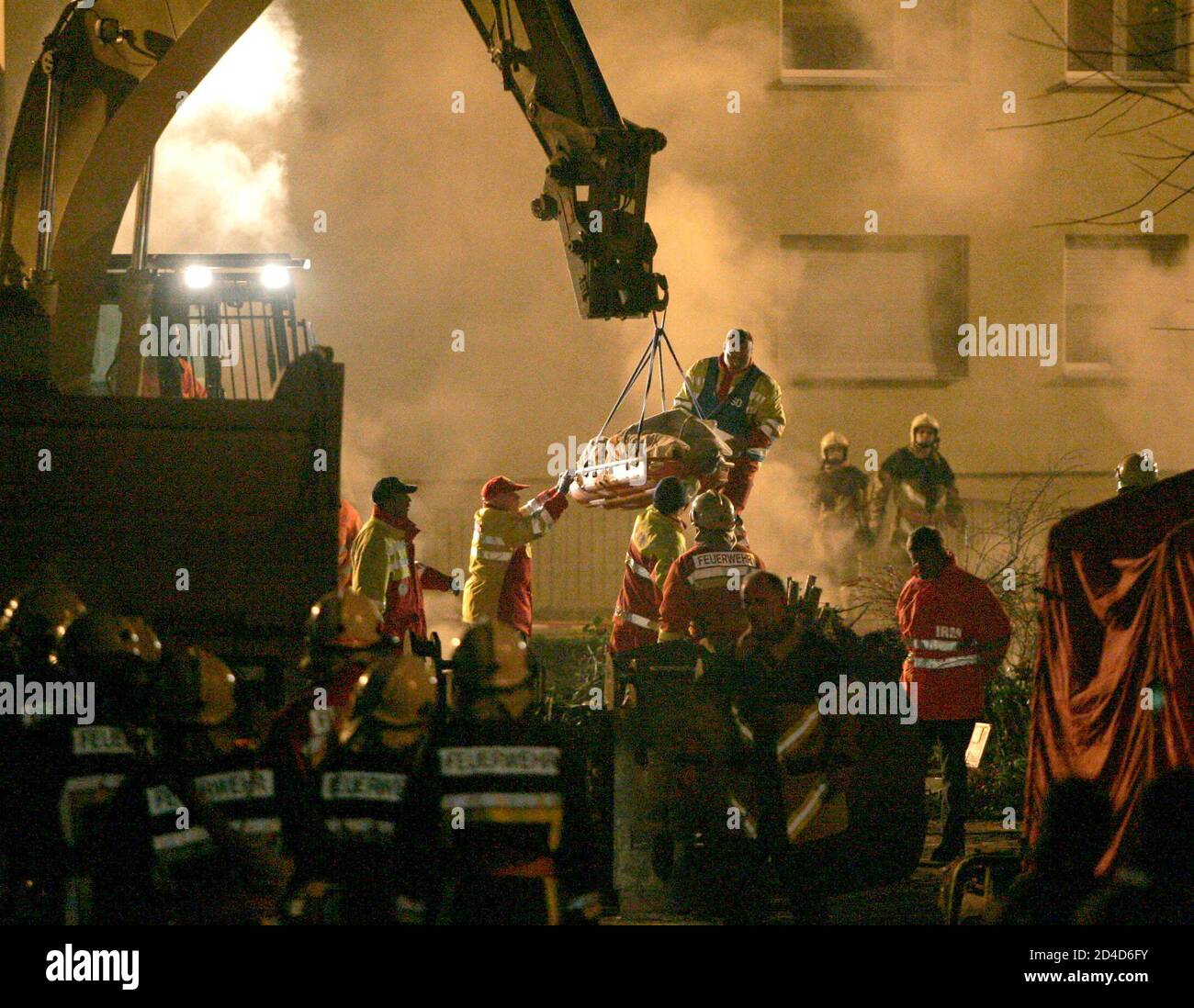 The body of a firefighter is lifted from an underground car park, the roof of which collapsed and buried up to seven firefighters underneath it in the town of Gretzenbach between the cities of Basel and Zurich November 27, 2004. Seven Swiss fire-fighters were presumed dead on Saturday after they were trapped under the collapsed roof of a burning underground car park."Of the seven persons, five have been located and show no signs of life, so we expect that they are dead," chief fire inspector Paul Haus said. All seven were thought to have suffocated. REUTERS/Ruben Sprich  RS/ABP Stock Photo
