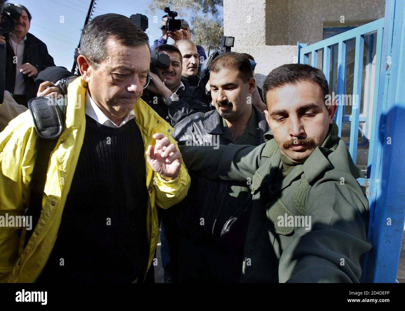 AN IRAQI SOLDIER MAKES ROOM FOR A U N INSPECTOR AT CENTRE FOR THE 