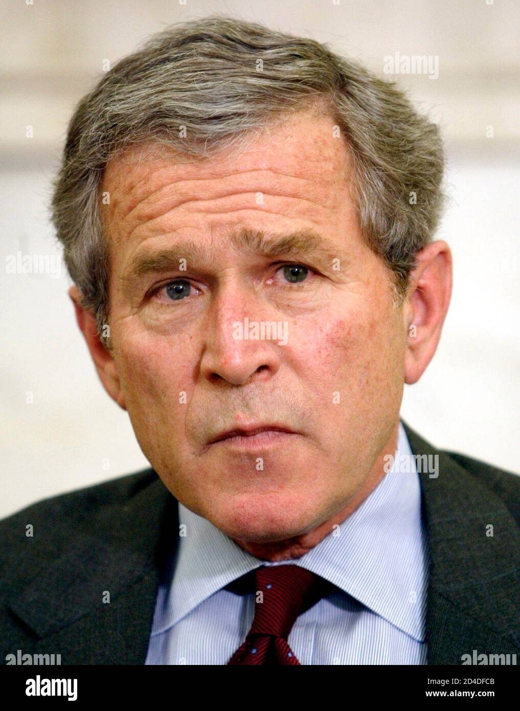 President George W. Bush looks up during a meeting with congressional leaders in the Oval Office of the White House March 21, 2003. Bush held the meeting to brief the leaders on the war in Iraq and to discuss domestic issues. The White House today said that the war in Iraq could still be 'lengthy and dangerous' and there were 'many risks ahead' for U.S. and British forces. REUTERS/Kevin Lamarque  KL Stock Photo