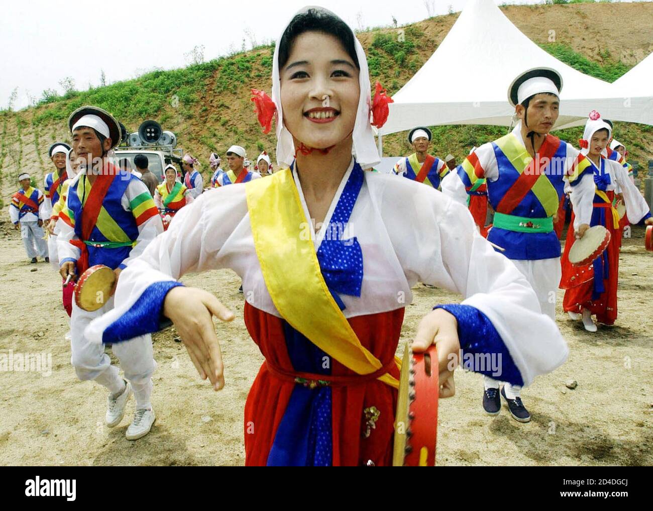 North Korean dancers perform off during a ground-breaking ceremony for an industrial park in Kaesong, North Korea June 30, 2003. North and South Korean officials and businessmen broke ground on Monday for a industrial park in the North that is intended to develop economic ties despite a row over Pyongyang's nuclear arms plans. Pool reports from Kaesong said construction would start next year on a project that will marry South Korean capital and technology with communist North Korea's cheap labour to help revive the North's near-moribund economy. REUTERS/Ahn Young-joon/Pool  CP Stock Photo