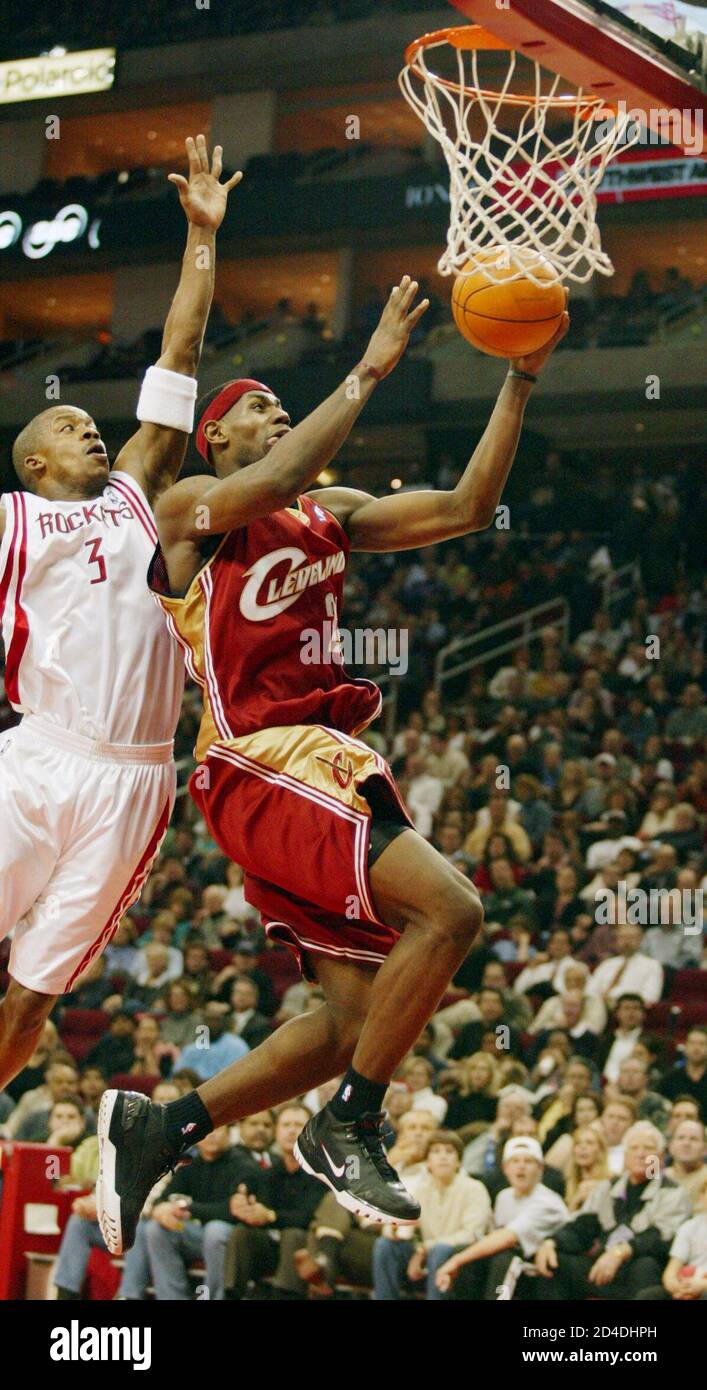 Cleveland Cavaliers guard LeBron James (R) drives to the basket and misses  his shot but is fouled by the Houston Rockets Steve Francis (L) on the play  in the second period February