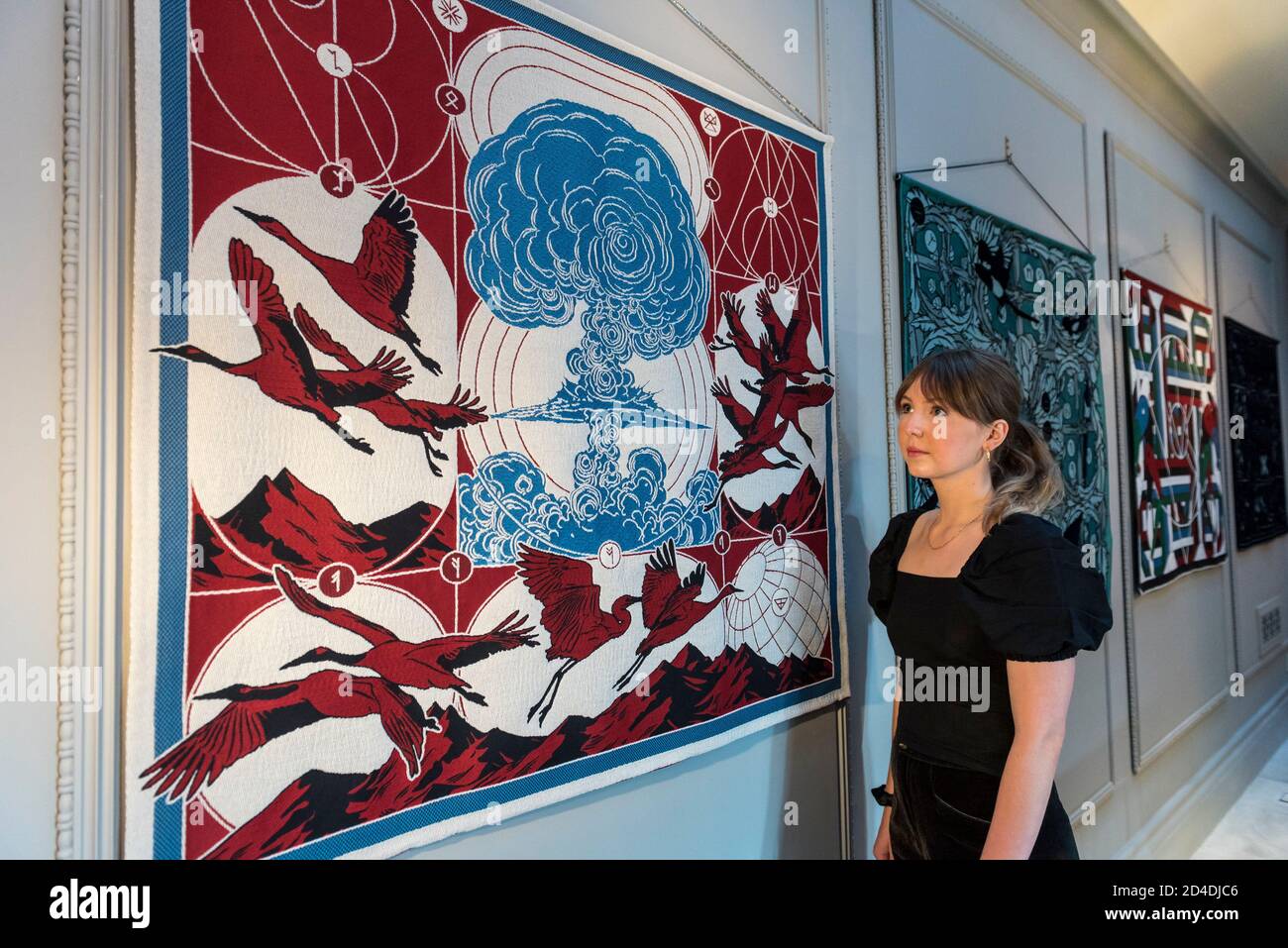 London, UK. 9 October 2020. A staff member views a series of silk hangings  by Berke Yazicioglu, illustrating Stravinsky's The Rite of Spring, at the  launch of The House of Bandits in