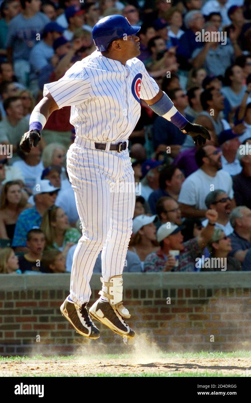Chicago Cubs right fielder Sammy Sosa watches his 36th home run of the season go out of Wrigley Field during the fifth inning of the game against the Cincinnati Reds in Chicago's Wrigley Field, August 11, 2000. Eric Young and Ricky Gutierrez also scored on the home run, hit off of Reds starting pitcher Rob Bell.  SUE/ME Stock Photo