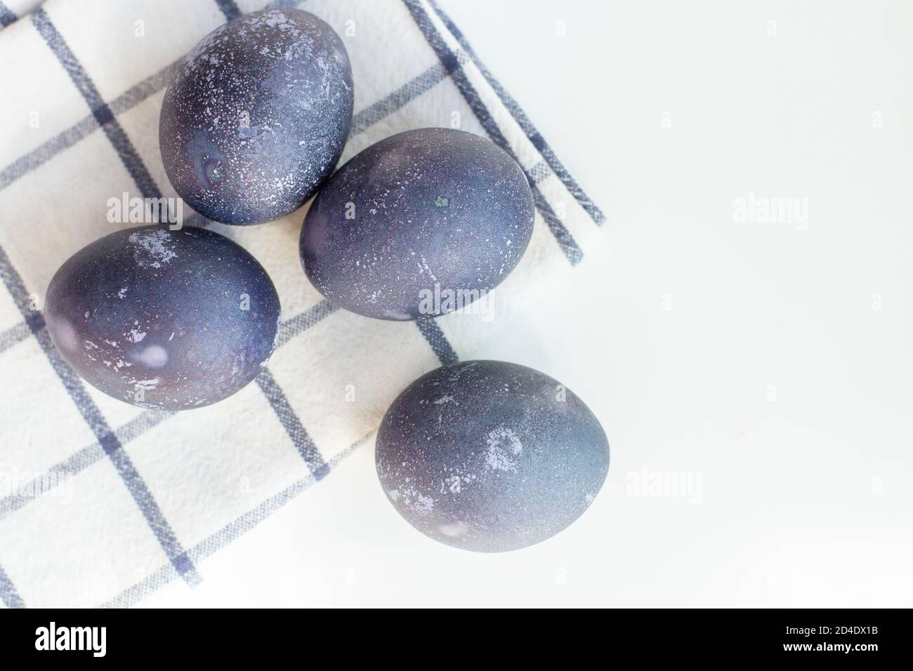 Blue easter eggs on a white checked towel Stock Photo