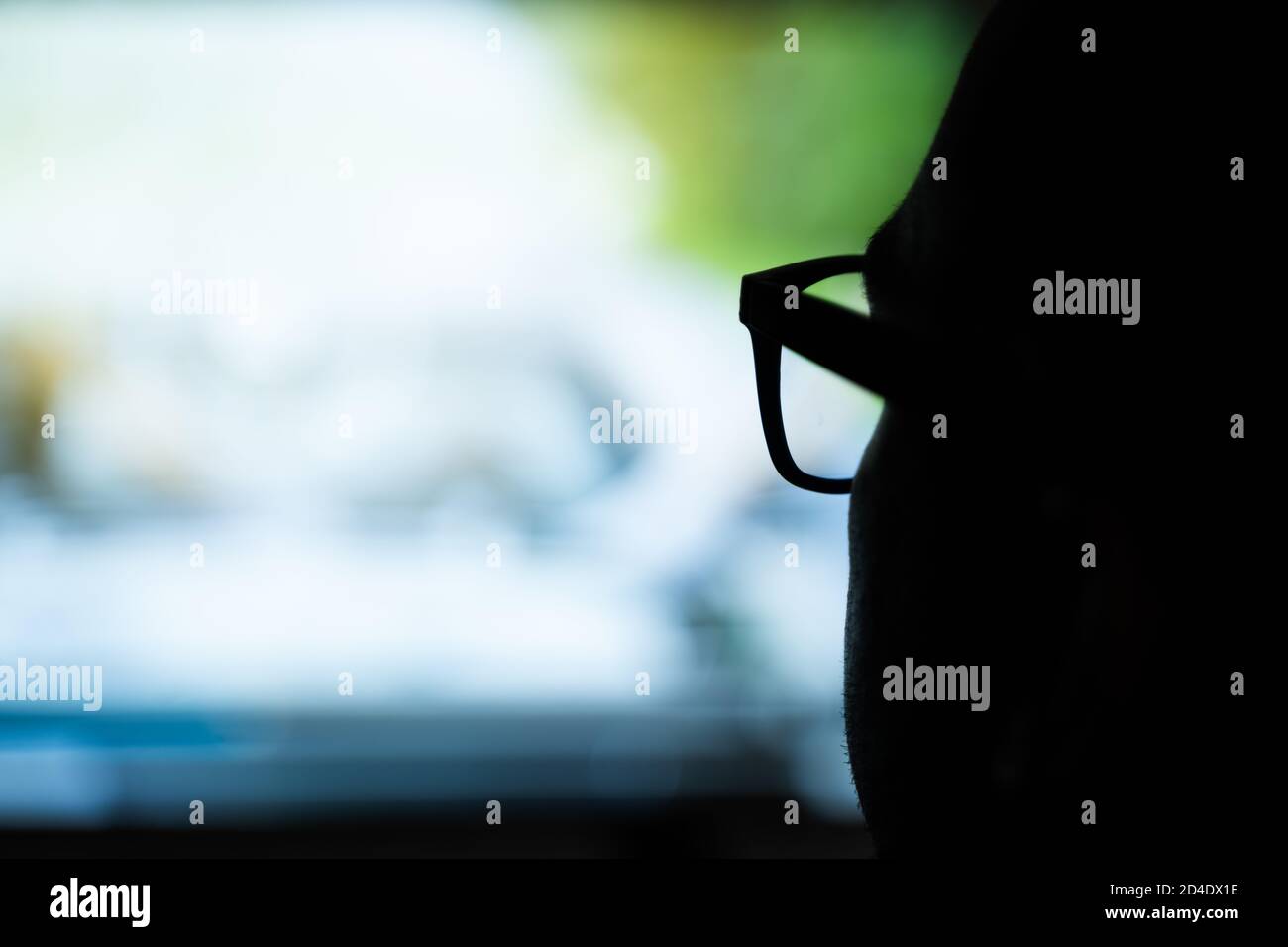 Man Using Magnifying Glasses for Watching TV Stock Photo