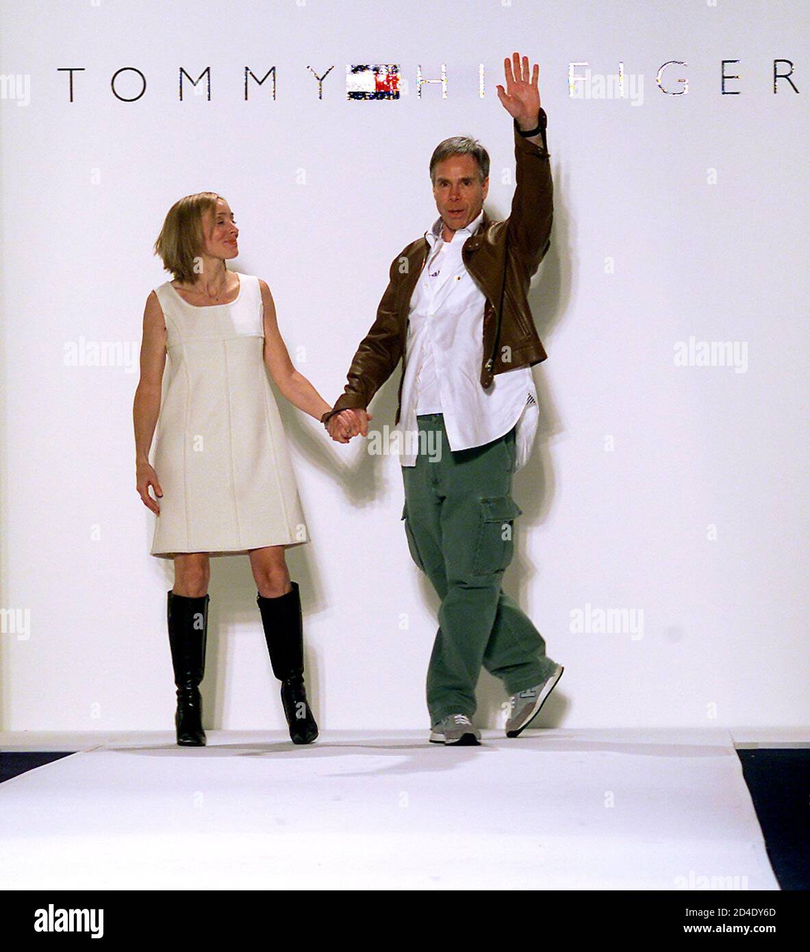 Designer Tommy Hilfiger waves to the audience as he and sister Ginny Hilfiger appear on the runway at the conclusion of presentation of the Tommy Hilfiger Fall/Winter 2002 Collection