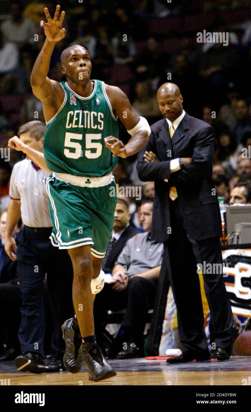 Boston Celtics forward Eric Williams celebrates his three-point basket in  front of New Jersey Nets head coach Byron Scott (R) late in the fourth  quarter of Game 2 of the NBA Eastern