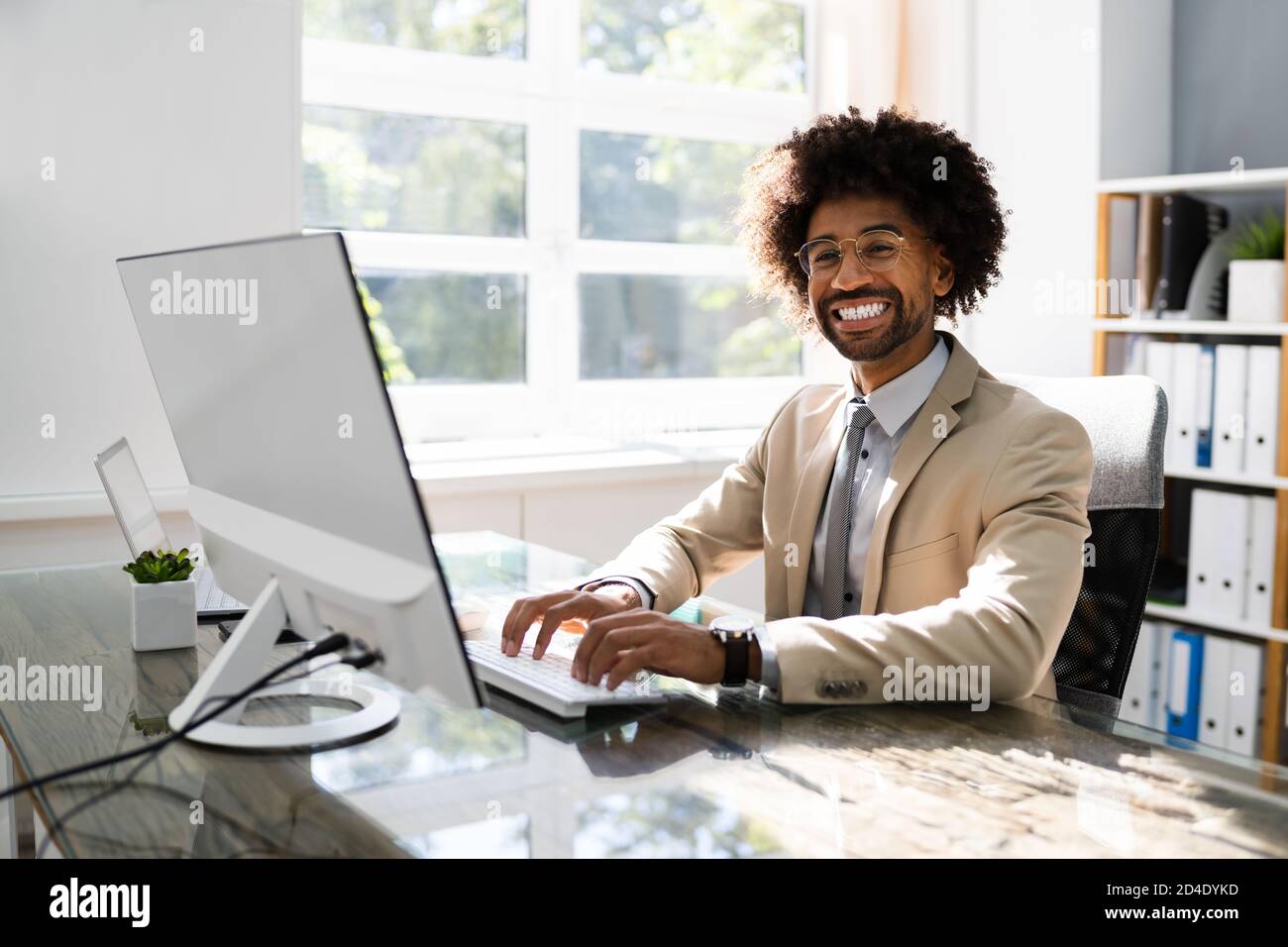 African American Business Man Using Computer In Office Stock Photo