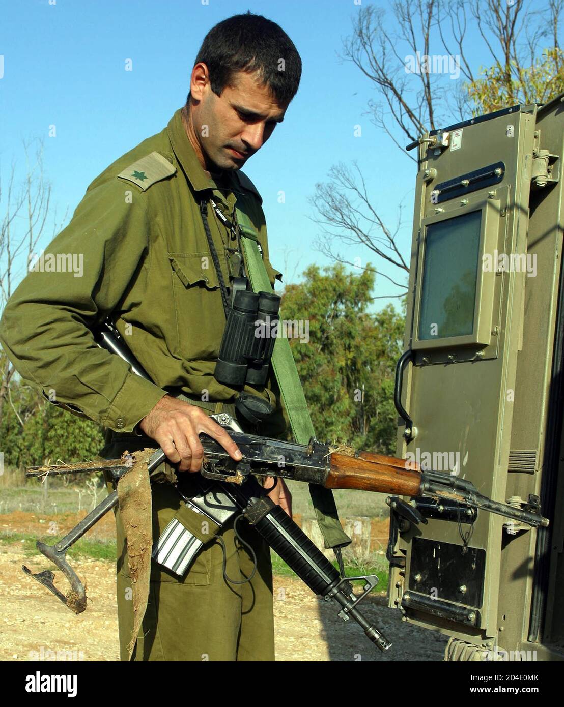 An Israeli army officer examines an AK-47 assault rifle in Bari, a Kibbutz  between teh Gaza Strip and Israel December 30, 2002. On Monday, troops  killed a Hamas militant who fought a