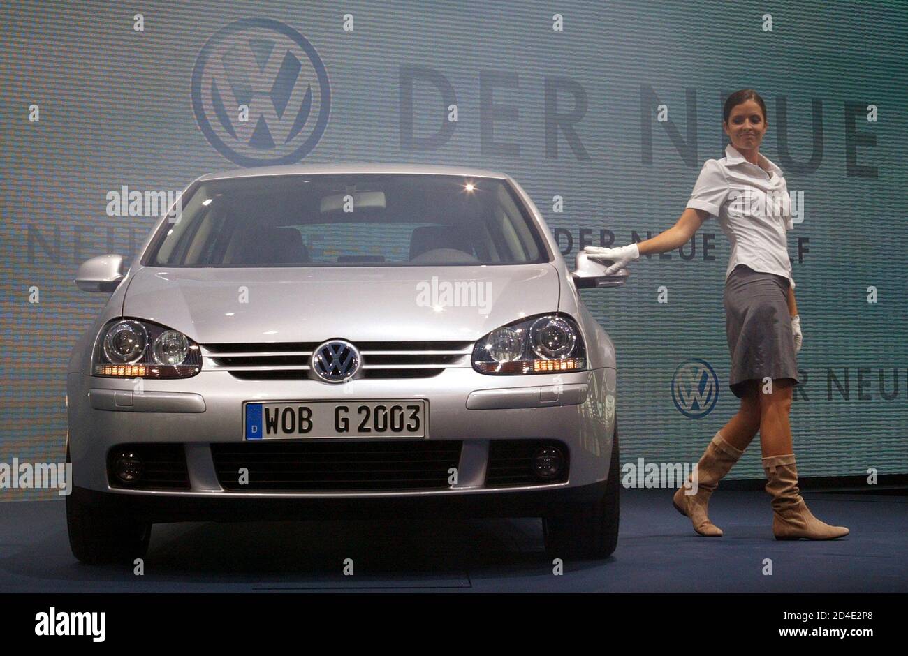 A model stands beside a new fifth generation Volkswagen Golf car during a  ceremony at the company's headquarters plant in Wolfsburg August 25, 2003.  Europe's biggest carmaker Volkswagen said on Monday it