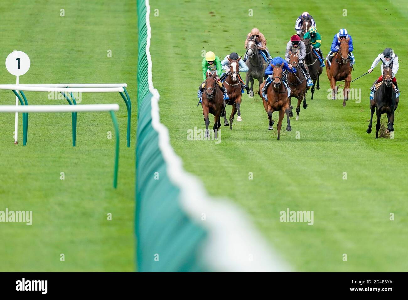 Divine Light ridden by William Buick (blue cap) wins The Godolphin Under Starters Orders Maiden Fillies' Stakes at Newmarket Racecourse. Stock Photo