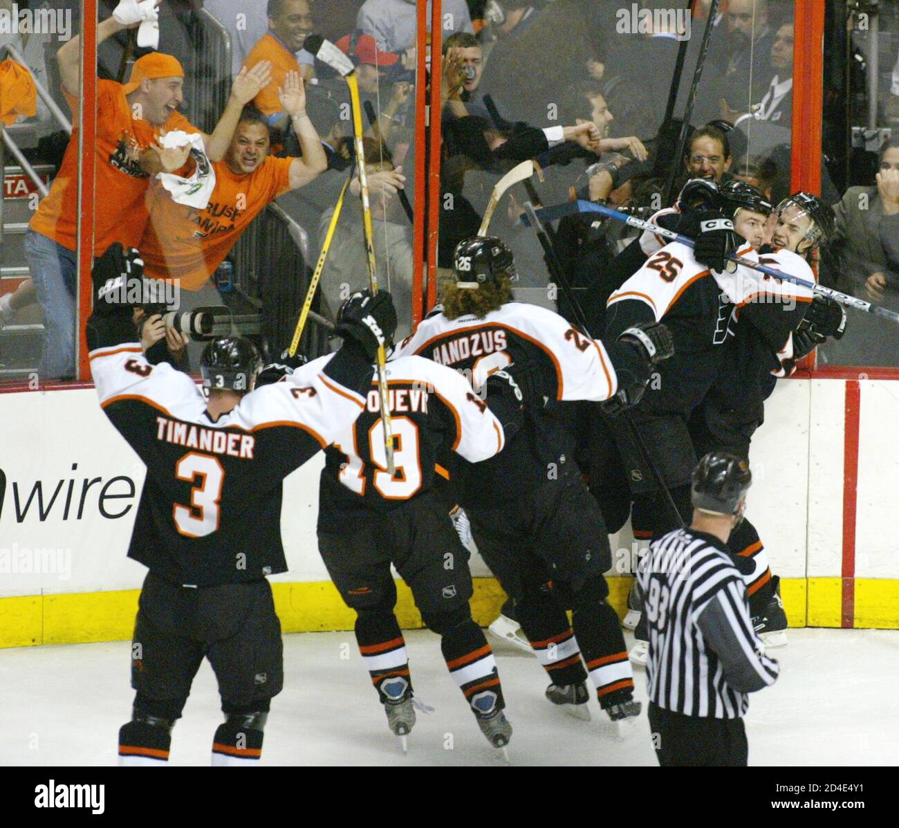 Philadelphia Flyers left winger Simon Gagne (R) celebrates with Keith  Primeau and other teammates after scoring the game winning goal in overtime  against the Tampa Bay Lightning in Game 6 of their