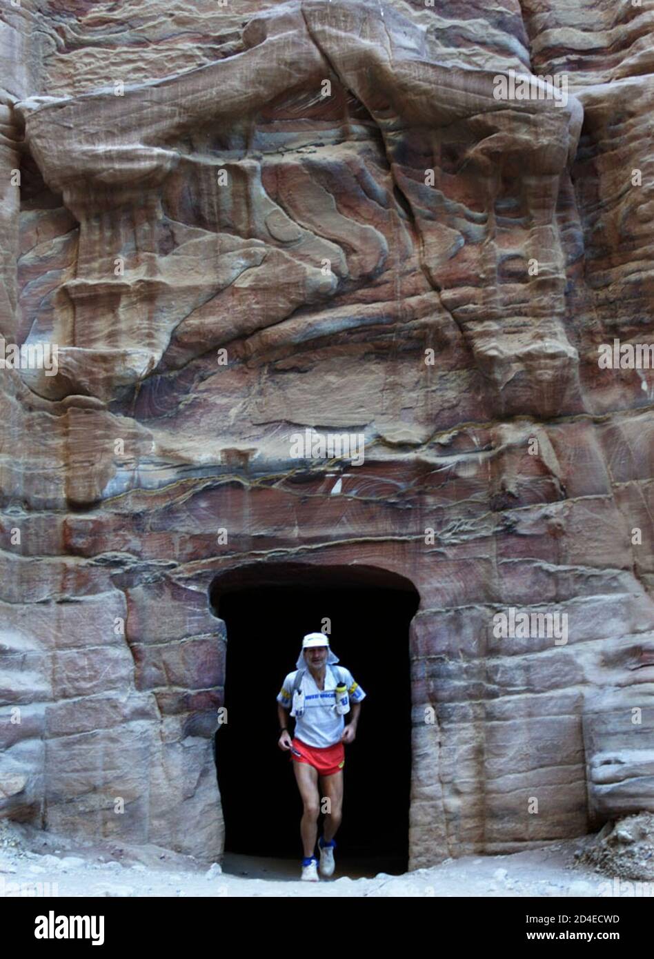 Marco Olmo, a 53-year-old from Italy, arrives through a rock face opening,  at the rose city of Petra November 9, 2001. Olmo won the 2001 Desert Cup on  Friday, 20 hours ahead