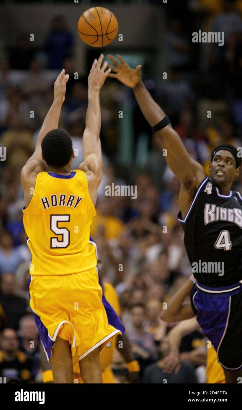 los-angeles-lakers-robert-horry-shoots-the-game-winning-three-point-shot-past-a-reaching-sacramento-kings-chris-webber-at-the-buzzer-of-game-4-of-the-nba-western-conference-finals-in-los