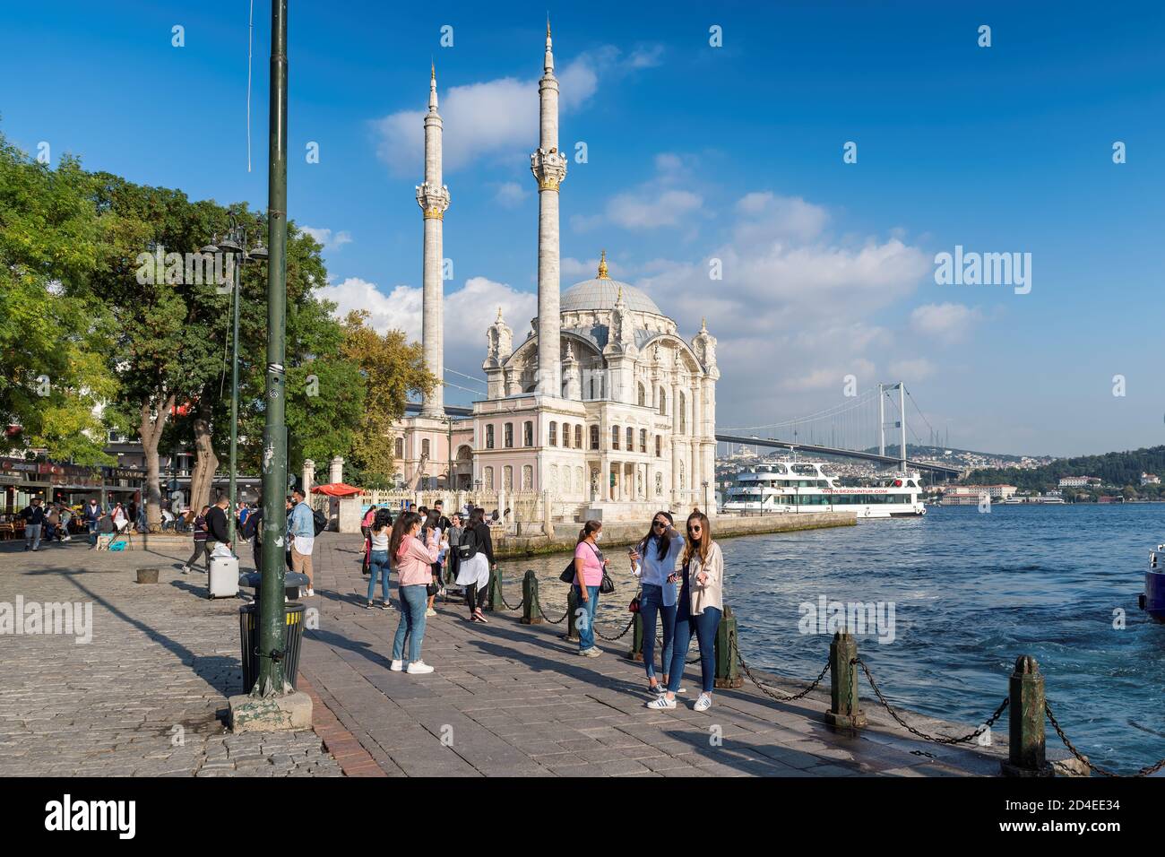 Tourists make a photo in Ortakoy Mosque with the Bosphorus Bridge Stock Photo
