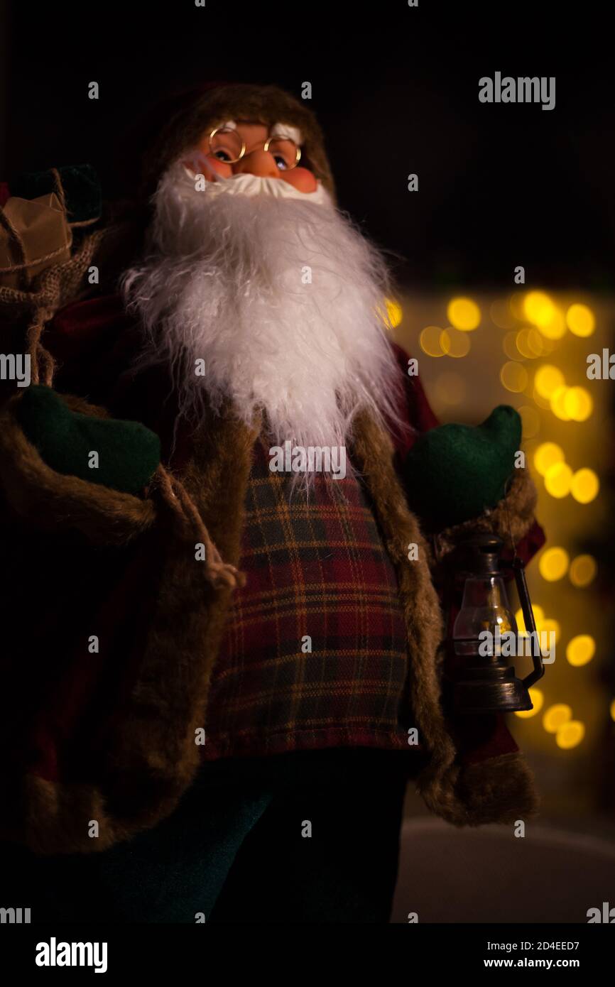 Santa Claus carrying big bag full of gifts, at home near Christmas Tree ...