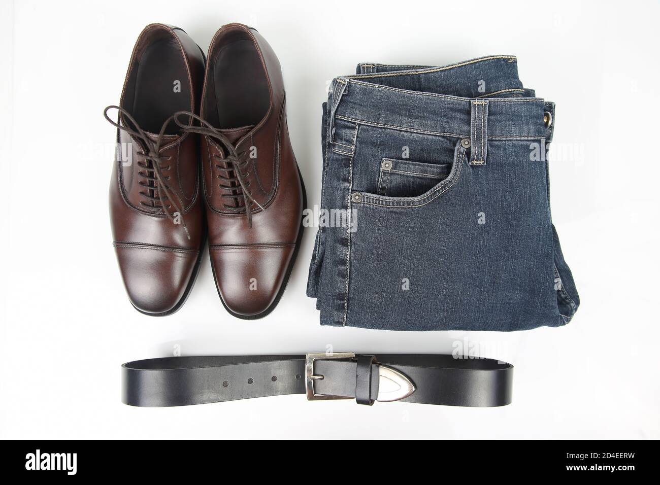 Classic men's brown shoes, belt and clothes on white background Stock