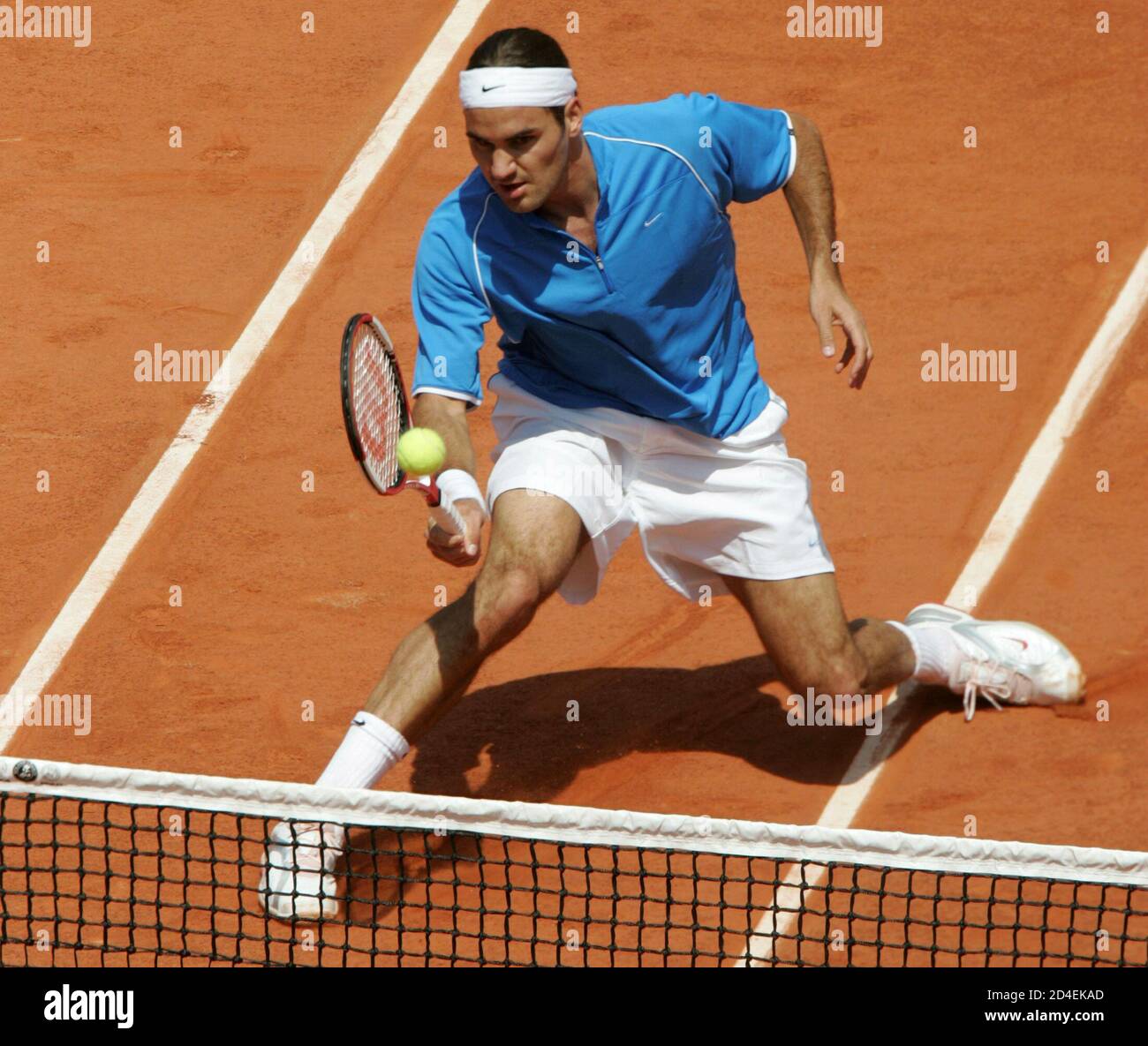 Roger Federer of Switzerland returns a forehand [to Gustavo Kuerten of  Brazil] in the French Open tennis tournament at Roland Garros stadium in  Paris, May 29, 2004. [Kuerten taught the world's best