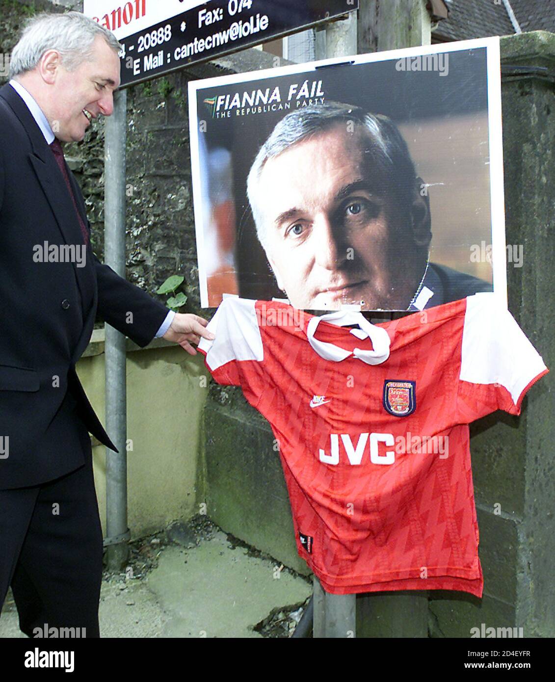 irish-prime-minister-taoiseach-bertie-ahern-laughs-at-spotting-one-of-his-election-posters-with-an-arsenal-football-club-top-in-letterkenny-county-donegal-republic-of-ireland-may-9-2002-ahern-is-canvassing-for-his-fianna-fail-party-ahead-of-the-irish-general-election-on-may-17-2002-reuterspaul-mcerlane-pmnmb-2D4EYFR.jpg