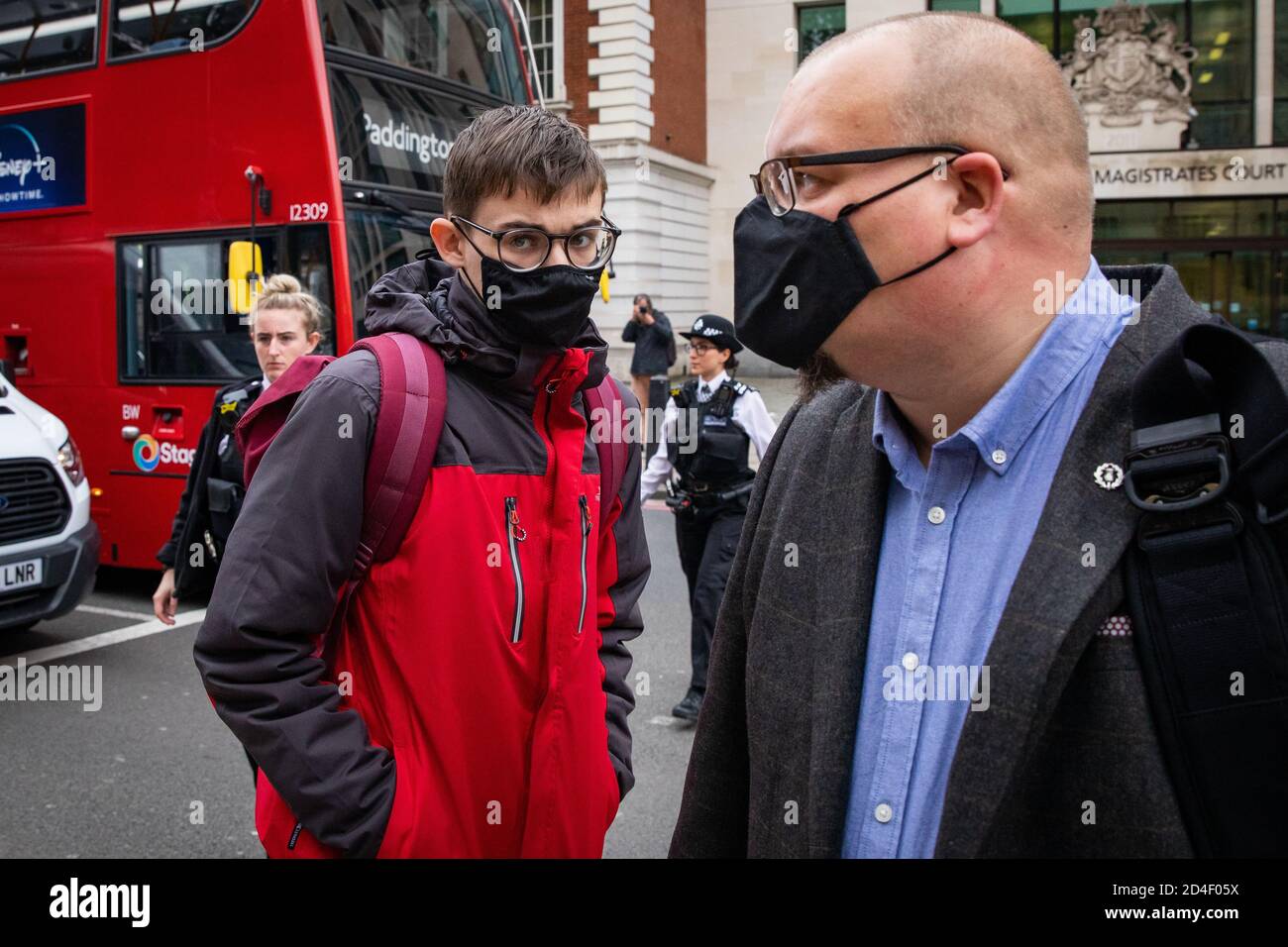 Benjamin Clark (left), 18, of Wilton Crescent, Hertford, and his father, Andrew Clark (right), exit Westminster Magistrates' Court in London, where Benjamin was charged with criminal damage to the Sir Winston Churchill statue in Parliament Square on September 10, the final day of ten days of Extinction Rebellion protests in the capital and admitted causing £1,642.03 worth of damage to the statue and spraying the word 'racist' in chalk paint, but denied causing all the damage to the statue done on the day. Deputy Chief Magistrate Tan Ikram handed down a £200 fine and ordered Clark to pay £1,200 Stock Photo