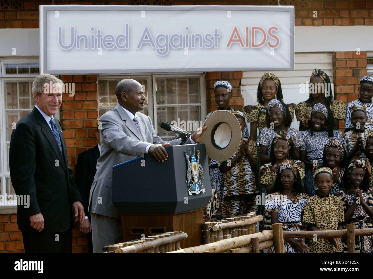 U S President George W Bush Listens As Ugandan President Yoweri Museveni Talks Next To The Orphaned Children Of Ugandan Parents Who Have Died Of Aids At The Aids Support Organisation Taso Center
