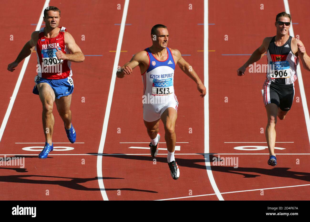 Athletes cross the finish line in men's 100 metres event of the decathlon  at the Athens 2004 Olympic Games. Athletes (L-R) Russia's Lev Lobodin,  Czech Republic's Roman Sebrle and Germany's Dennis Leyckes