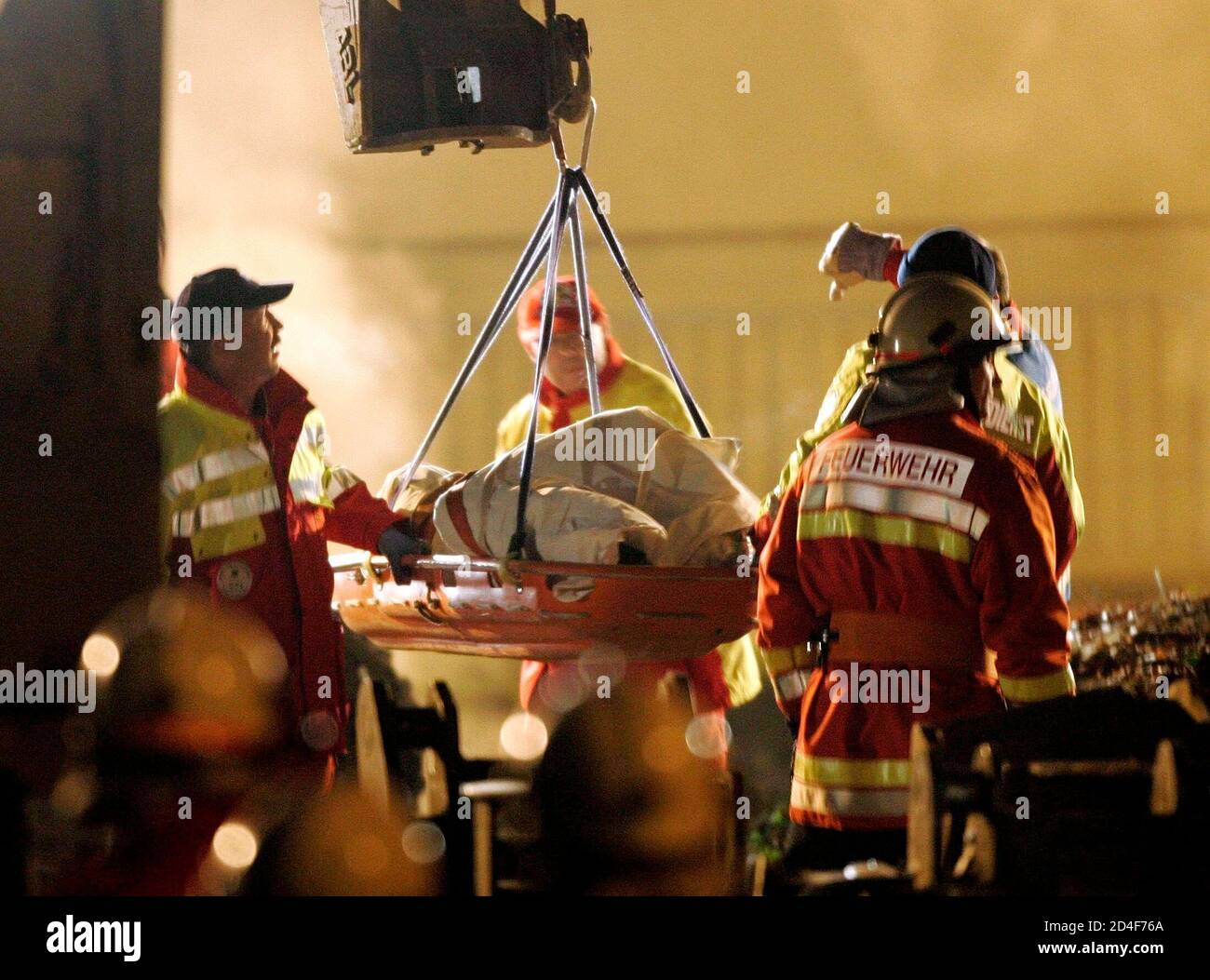 The body of one firefighter is lifted from an underground car park, the roof of which collapsed and buried up to seven firefighters underneath it in the town of Gretzenbach between the cities of Basel and Zurich November 27, 2004. Construction experts, earthquake rescue specialists and other fire and rescue personnel raced against time to find the men who had been battling a fire in the residential car park when the roof caved in and trapped them in its rubble. REUTERS/Ruben Sprich  RS/ABP Stock Photo