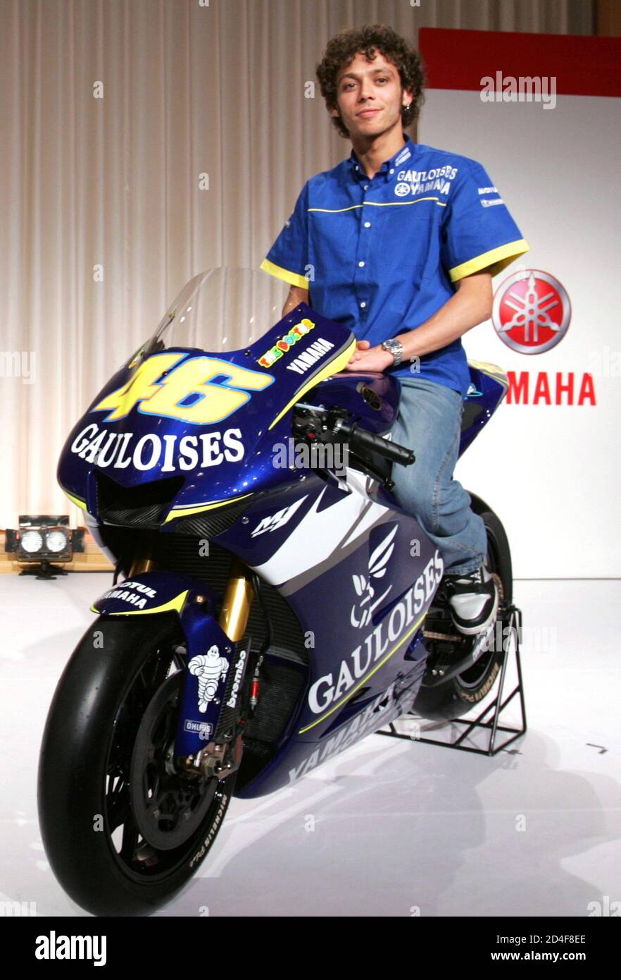 Italy's MotoGP world champion Valentino Rossi poses for photographers on  his new Yamaha YZR-M1 during a news conference in Tokyo March 7, 2005. The  26-year-old Italian will kick off his 2005 MotoGP