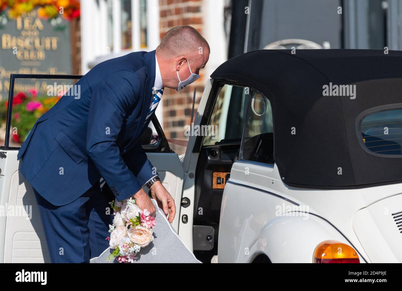 A worker wearing a face mask at a socially distanced COVID safe wedding event in the hospitality business during the Coronavirus pandemic in the UK. Stock Photo