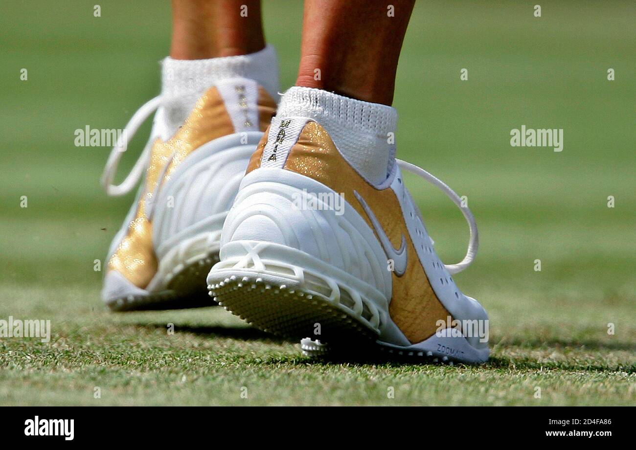 Russia's Maria Sharapova wears shoes bearing her name in her ladies'  singles second round match against Bulgaria's Sesil Karatancheva at the  Wimbledon tennis championships in London, June 23, 2005. REUTERS/Dylan  Martinez RD/SA