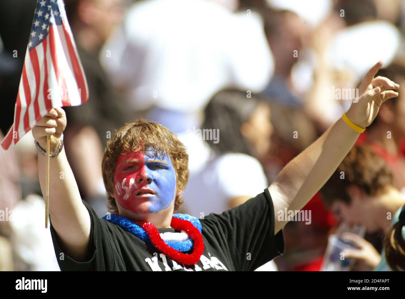 U.S. men's soccer team fan holds up an American flag after the U.S. beat the Canada in their Gold Cup match in Seattle.  U.S. men's soccer team fan,14-year-old Nick Bleich of Puyallup, Washington, holds up an American flag in celebration after the U.S. team beat Canada 2-0 in their Confederation of North, Central American and Caribbean Association Football (CONCACAF) Gold Cup soccer match at Qwest Field in Seattle, Washington, July 9, 2005. REUTERS/Anthony P. Bolante Stock Photo