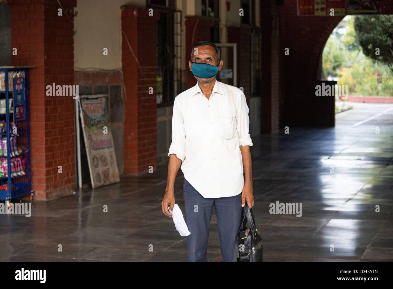 Dehradun, Uttarakhand/India-September 12 2020:A Bus conductor wearing face mask at the bus station, waiting for passengers. Stock Photo
