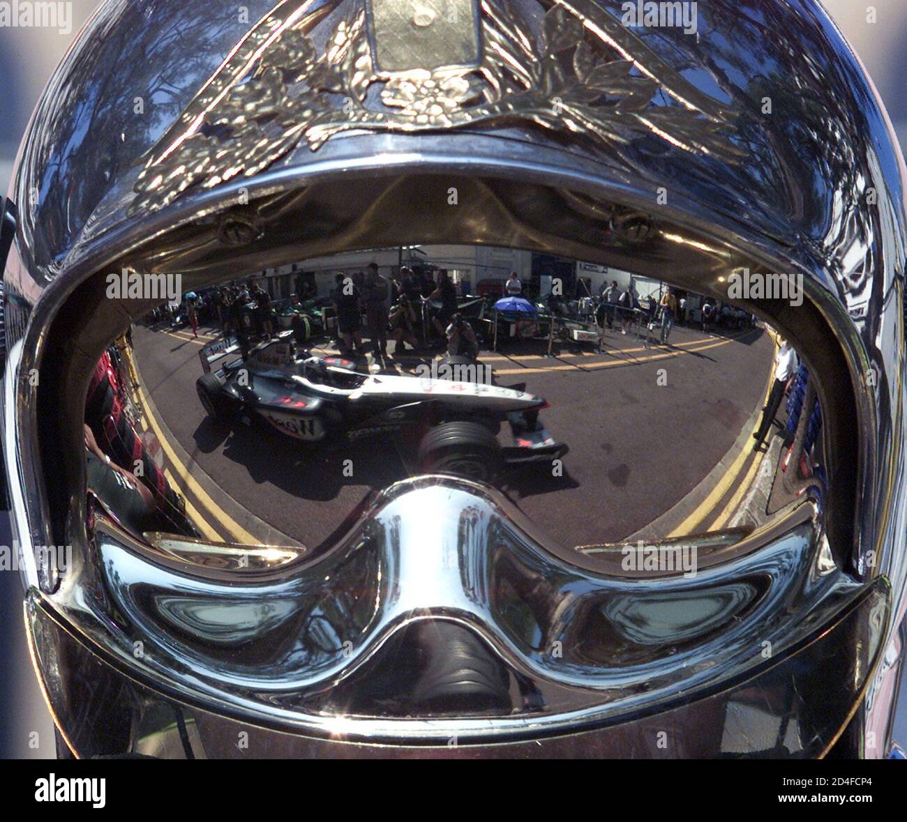 Scottish Formula One driver David Coulthard in his McLaren Mercedes is  reflected in the helmet of a fireman during the qualifying session of the  Monaco Grand Prix in Monte Carlo, May 26,