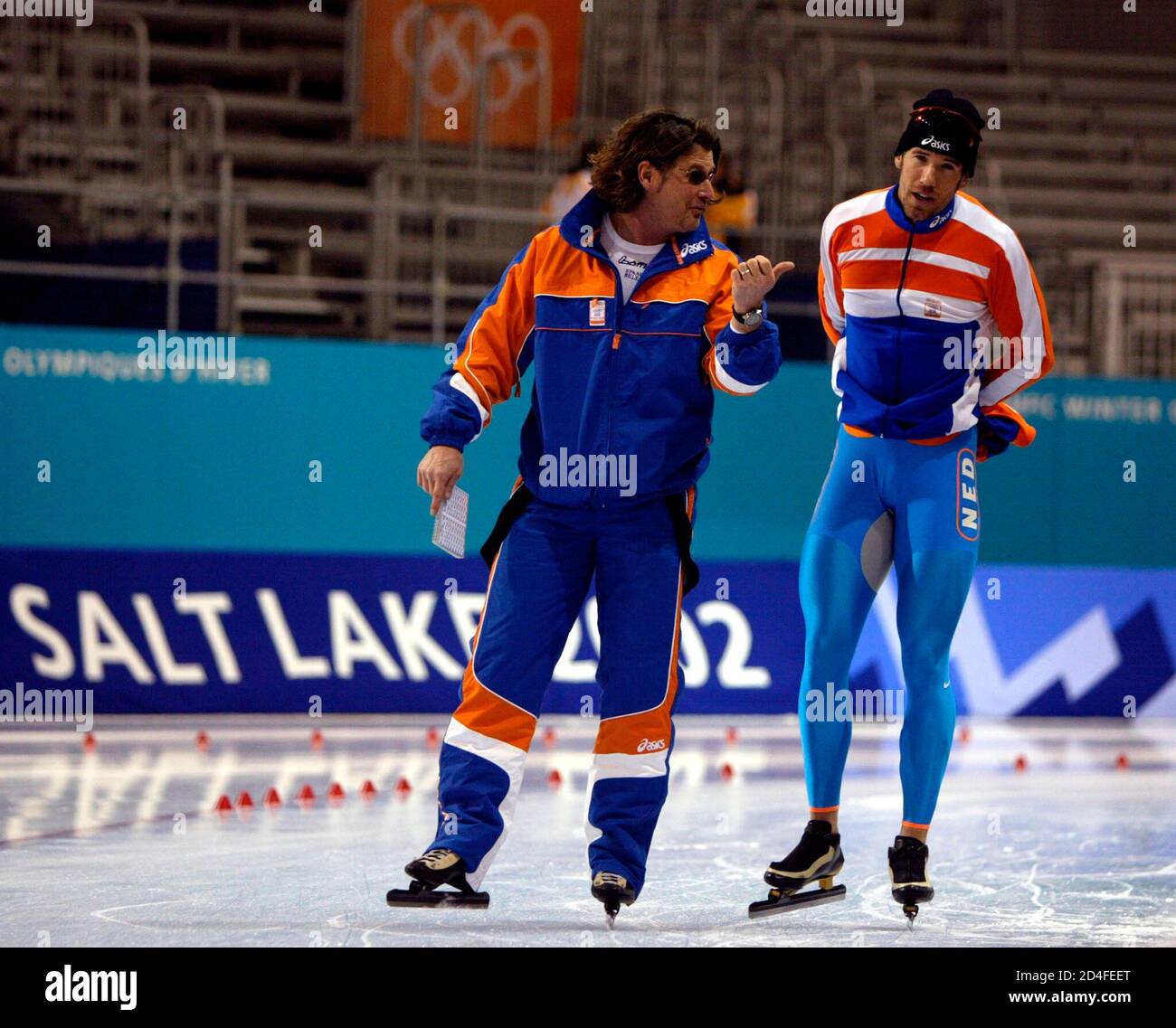 Dutch speed skater Gianni Romme (R) talks to his coach, American Peter  Mueller (R), in the Olympic speedskating stadium in Salt Lake City,  February 2, 2002. The XIX Winter Olympic Games will