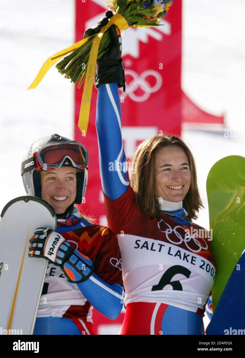 Isabelle Blanc (R) and Karine Ruby of France stand together after Blanc won  the gold medal in the women's snowboard parallel giant slalom at the Salt  Lake 2002 Olympic Winter Games in