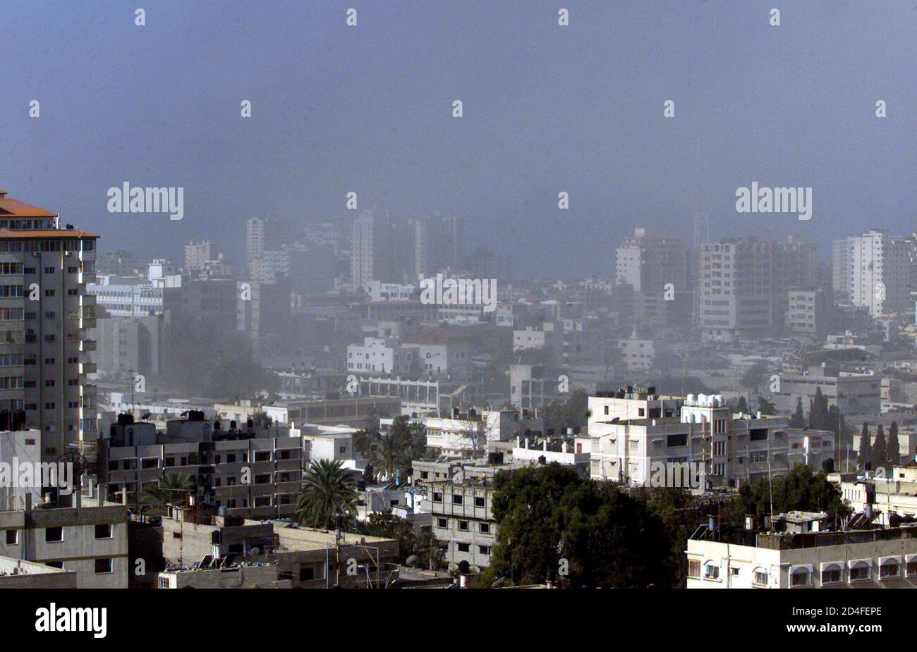 Smoke rises over Gaza city after Israeli warplane hit Palestinian police headquarters in Gaza March 7,2002. An Israeli warplane fired at least one missile at a Palestinian police headquarters in Gaza City on Thursday, wounding at least 10 people, witnesses and hospital sources said. Stock Photo