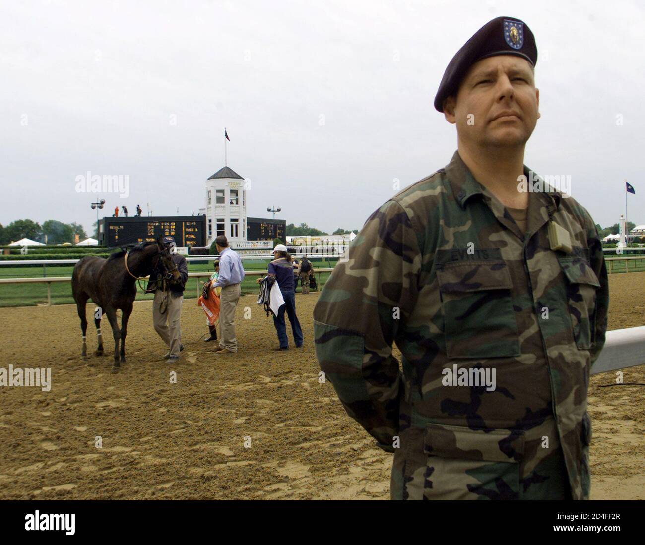Spc. Mark Evitts, a military police member from the 223rd Company of the Kentucky National Guard, stands guard at trackside of Churchill Downs in Louisville May 3, 2002. The 128th Kentucky Derby will be run May 4 with heightened security. REUTERS/Tami Chappell  PJ Stock Photo