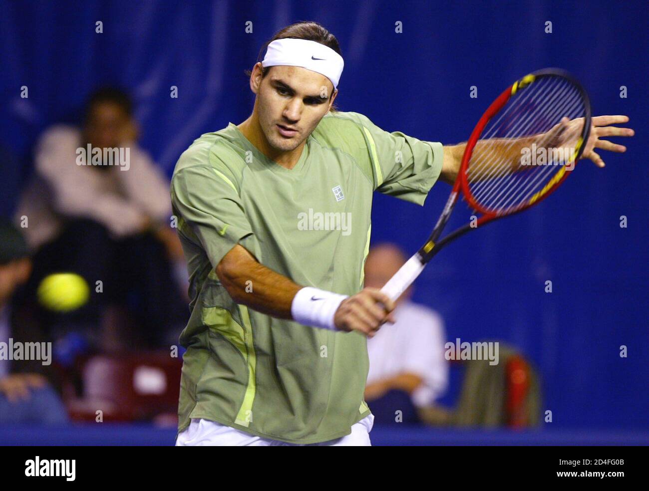 Roger Federer of Switzerland hits a backhand return to Xavier Malisse of  Belgium in their first round match at the Tennis Masters Paris ATP indoor  tournament at Bercy'stadium, October 30, 2002. Federer