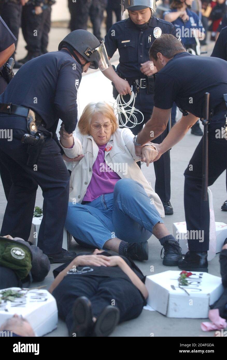 One of sixteen people arrested in front of the Federal Building in downtown Los Angeles is taken into custody, January 16, 2003, during a civil disobedience protest against war on Iraq. The arrest followed a mock funeral with the sixteen lying on the sidewalk next to cardboard coffins. REUTERS/Jim Ruymen  JR/ME Stock Photo