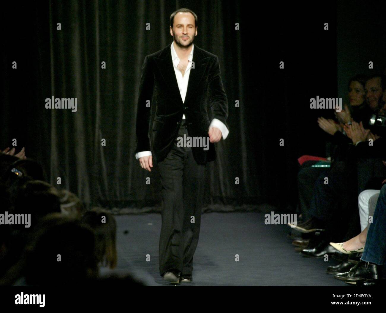 American designer Tom Ford for fashion house Yves Saint-Laurent Rive Gauche  walks on the catwalk after his show for Autumn/Winter 2003-04 ready-to-wear  collection in Paris March 10, 2003. The Paris fashion shows
