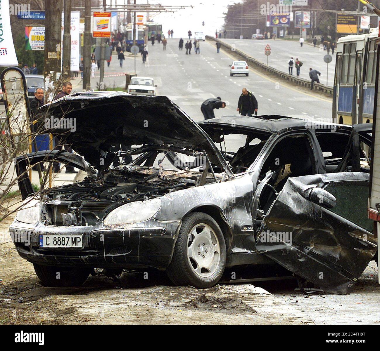 Bulgarian plainclothes policemen ivestigate an explosion that blew up a Mercedes car, killing passanger and injuring the driver on Sofia's central Tsarigradsko Shosse boulevard on April 18, 2003. Police closed the six-lane boulevard and launched investigation into the case. REUTERS/Stoyan Nenov  SN/ Stock Photo