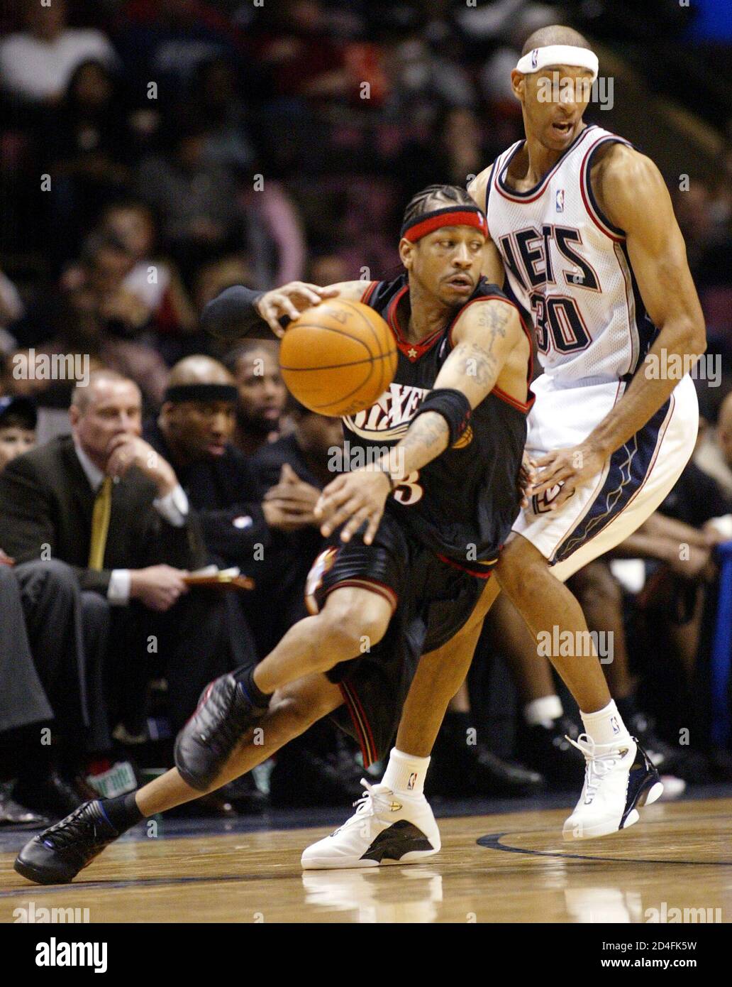 Philadelphia 76ers guard Allen Iverson (L) drives around New Jersey Nets  guard Jason Kittles (R) in the first period of their NBA game February 8,  2004 in East Rutherford, New Jersey. REUTERS/Ray