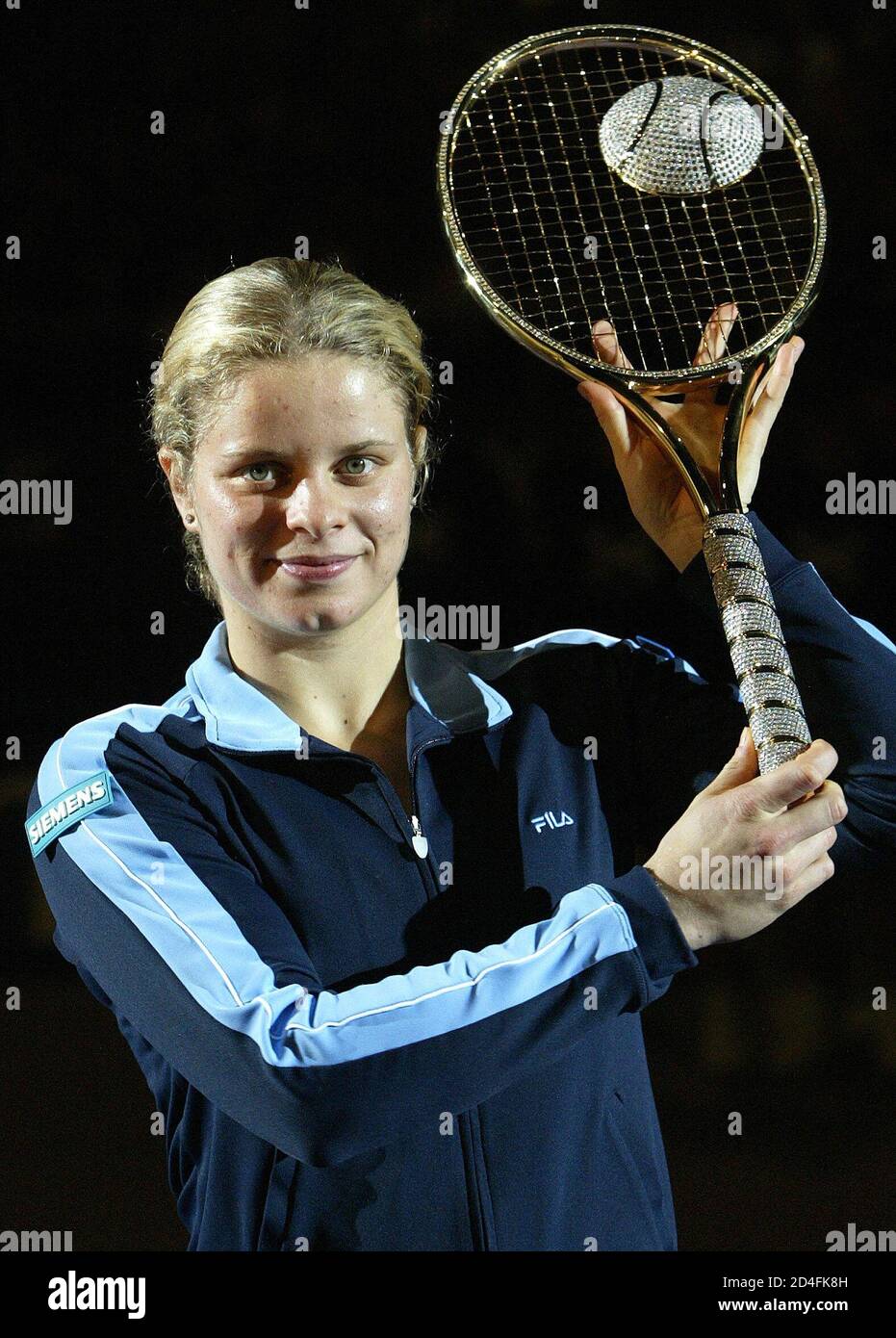 Belgium's Kim Klijsters holds up the Diamond racket trophy after defeating  Italy's Silvia Farina Elia in the final at the WTA Proximus Diamond Games  tournament in Antwerp February 22, 2004. Clijsters won