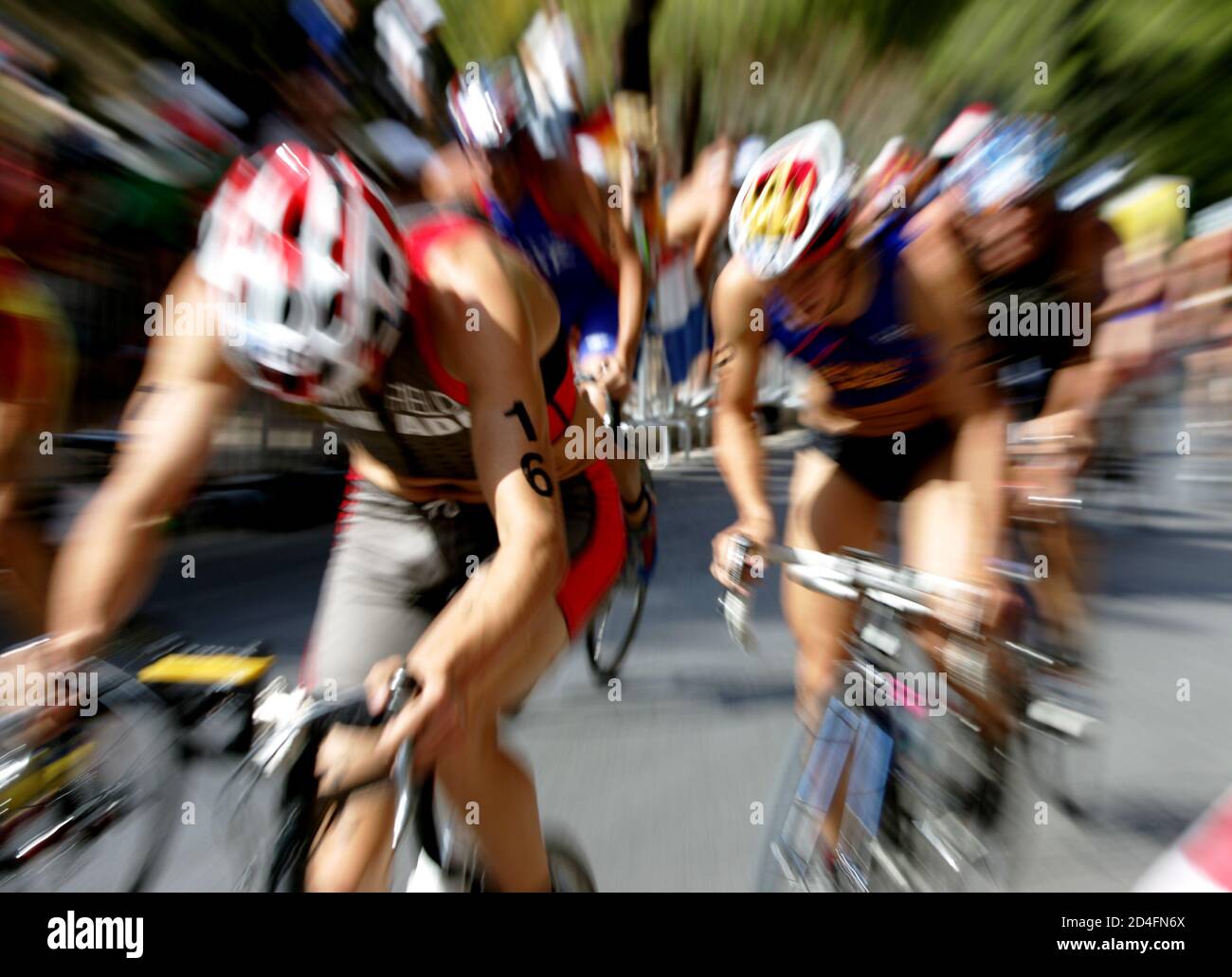 Competitors ride bikes during the men's triathlon event at the Athens 2004 Olympic Games, August 26, 2004. Hamish Carter of New Zealand won the men's triathlon gold medal at the Olympics on Thursday ahead of compatriot Bevan Docherty who took the silver and Sven Riederer of Switzerland the bronze. REUTERS/Kim Kyung-Hoon  KKH/DL Stock Photo