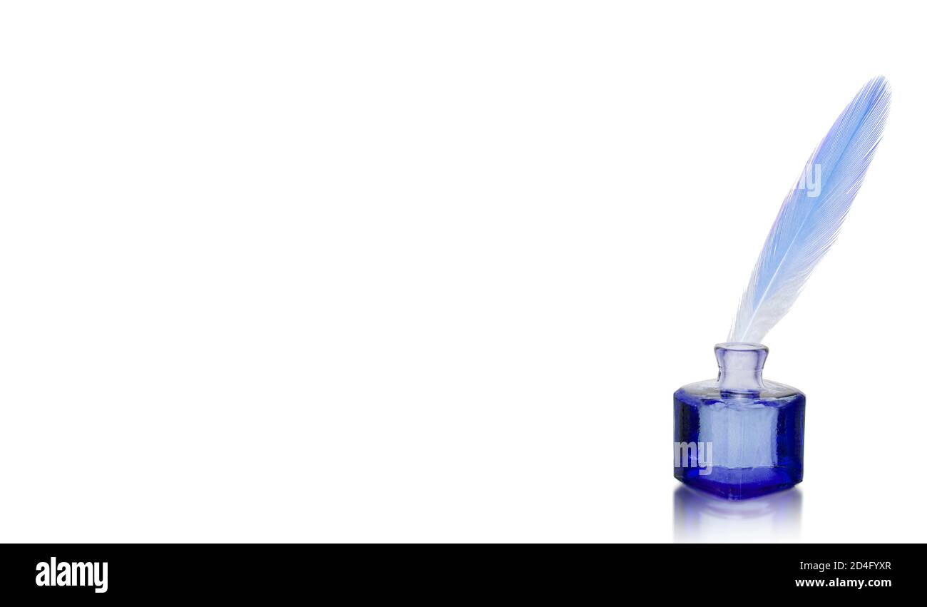 Feather pen into the inkwell. Isolated on a white background Stock